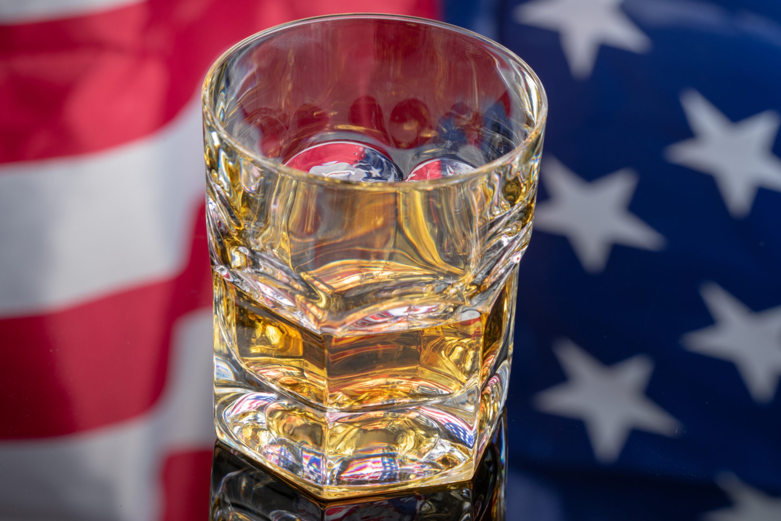 glass-of-whiskey-on-mirror-background-with-america-2026-01-06-09-23-29-utc